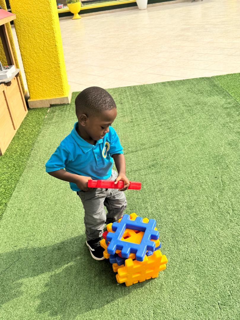 Child playing with large building pieces